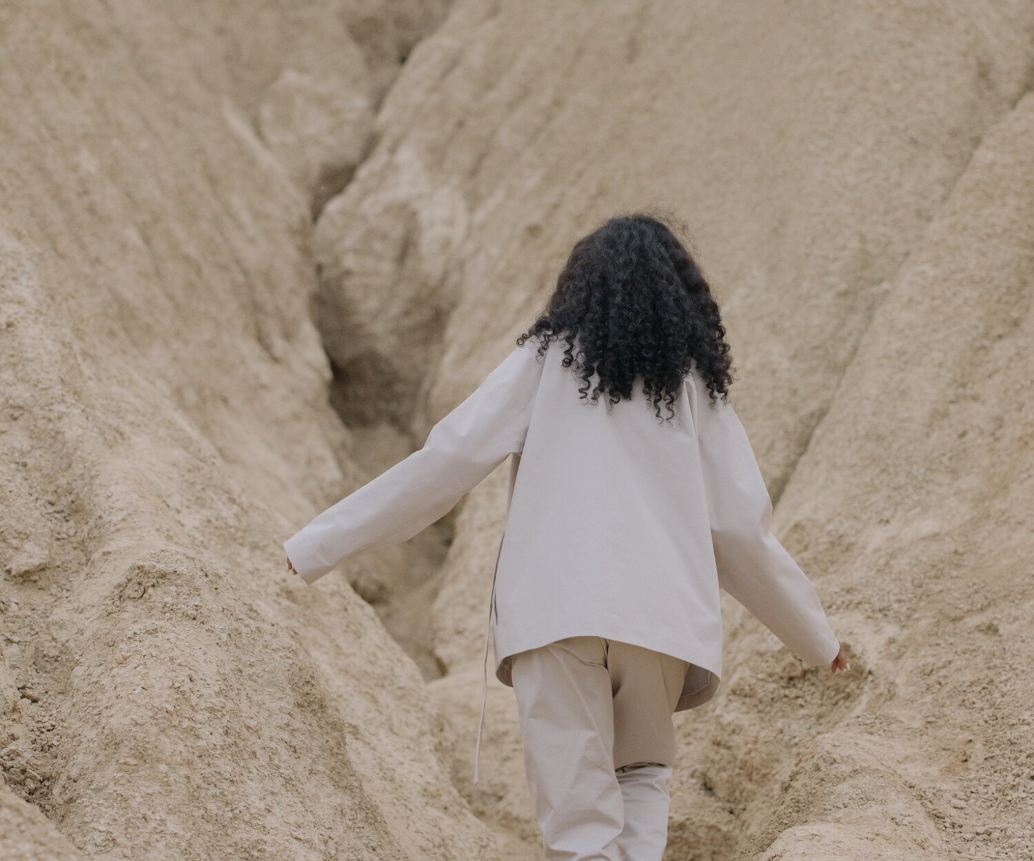 Woman climbs between rocks
